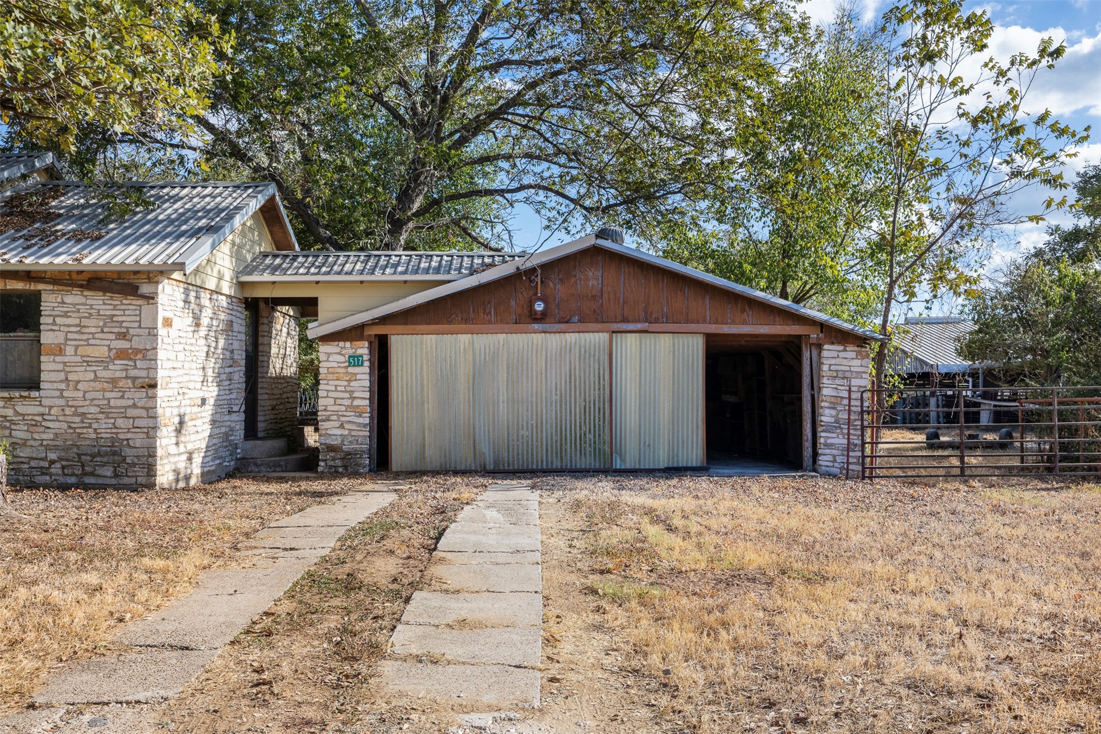 517 First Street Lexington, TX 78947 - Photo 5 of 37 a front view of a house with yard and seating area