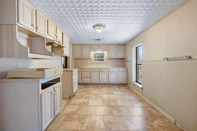 a kitchen with white cabinets and white appliances