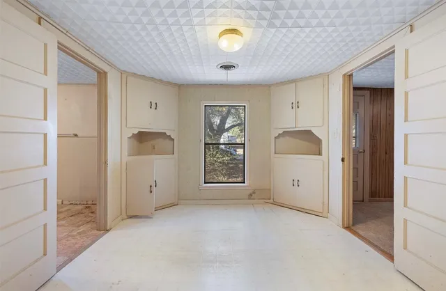 a view of a room with a sink and mirror