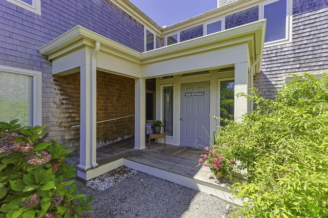 a view of a brick house with potted plants