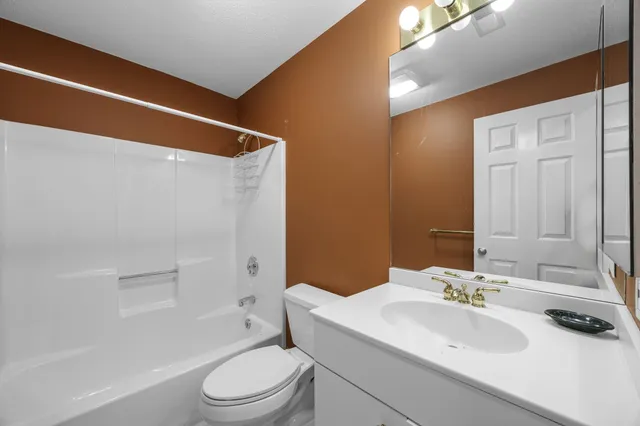 a bedroom with a bed and a mirror