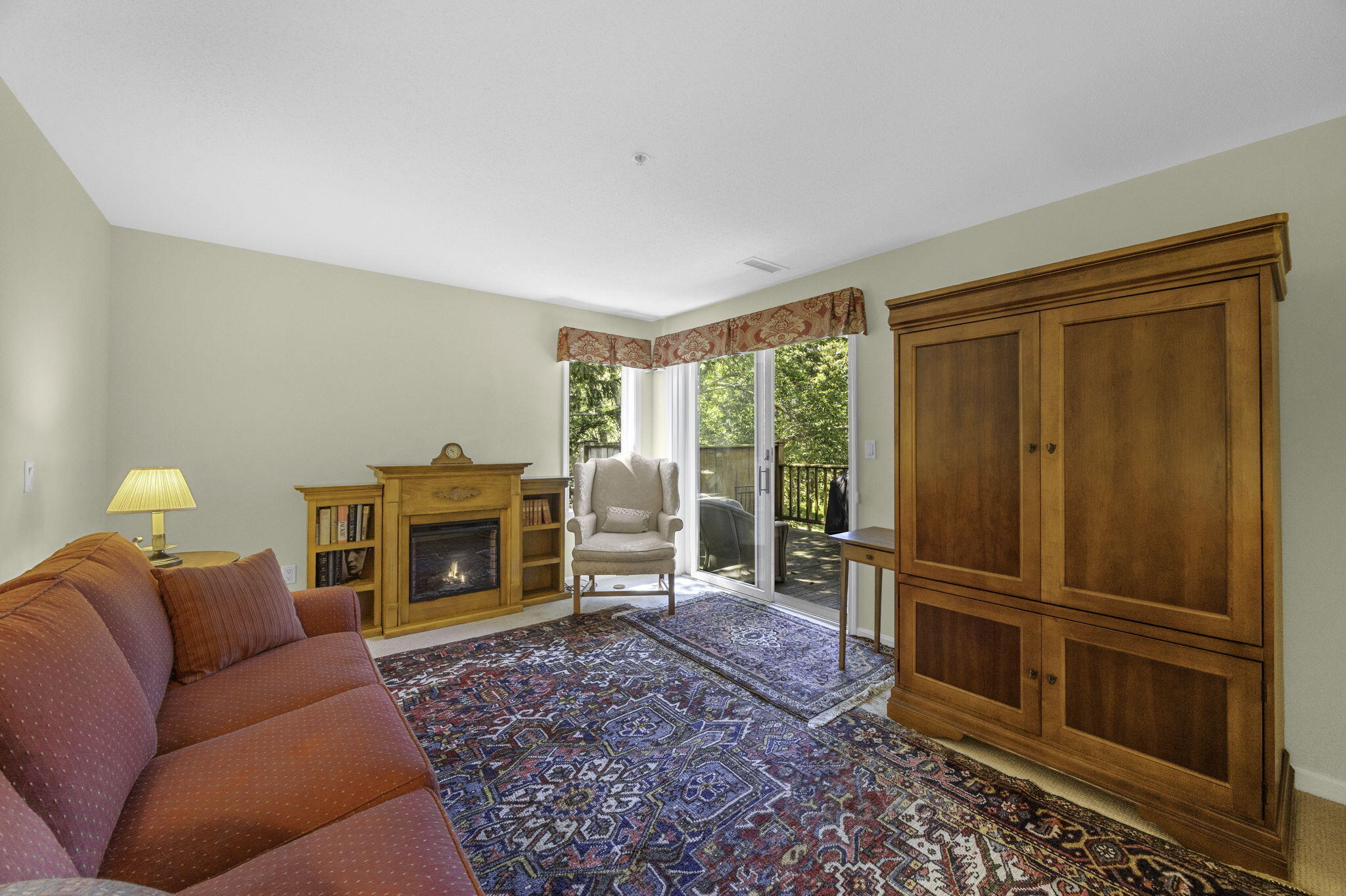 228 Kates Path Yarmouth Port, MA 02675 - Photo 16 of 30 a living room with furniture a flat screen tv and a fireplace