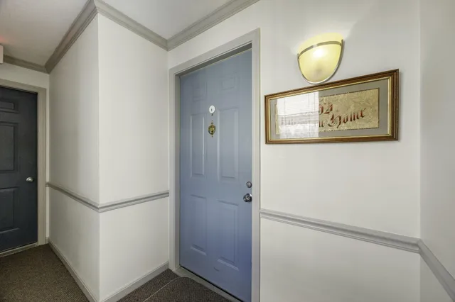 a view of room with chandelier fan and wooden floor