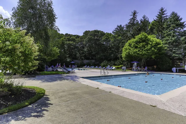 a front view of a house with a yard and a garage
