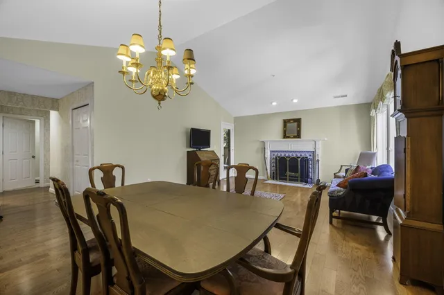 a living room with furniture a rug and a dining table