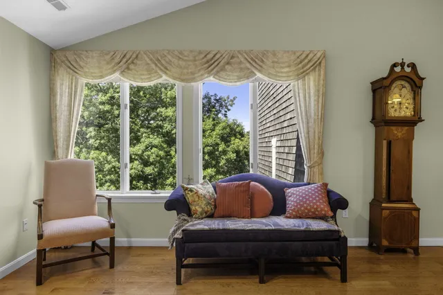 a living room with a fireplace and a window