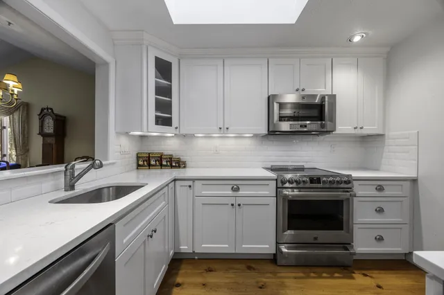 a kitchen with a sink stove and cabinets