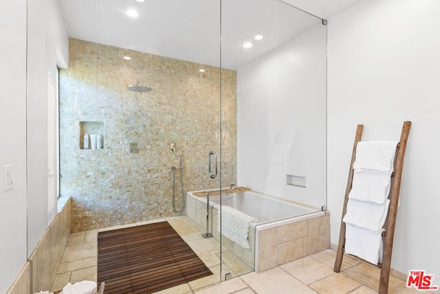 a bathroom with a bathtub and a shower