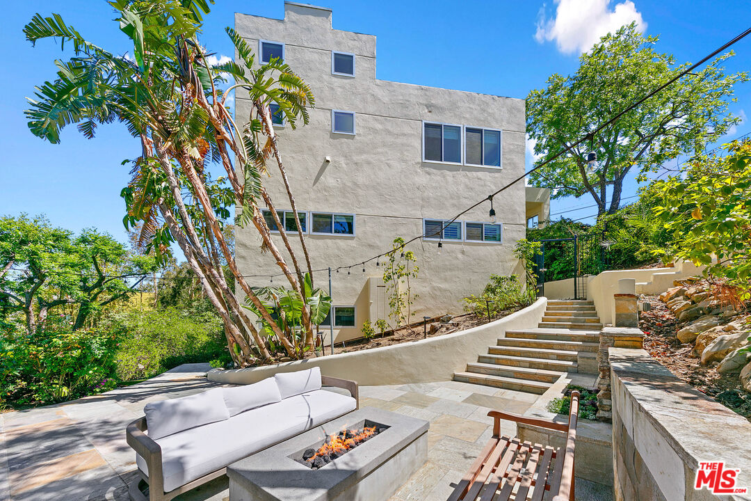 1876 Lookout Road Malibu, CA 90265 - Photo 32 of 44 a view of a patio with couches table and chairs and potted plants