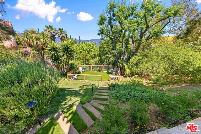 a view of an house with backyard and sitting area