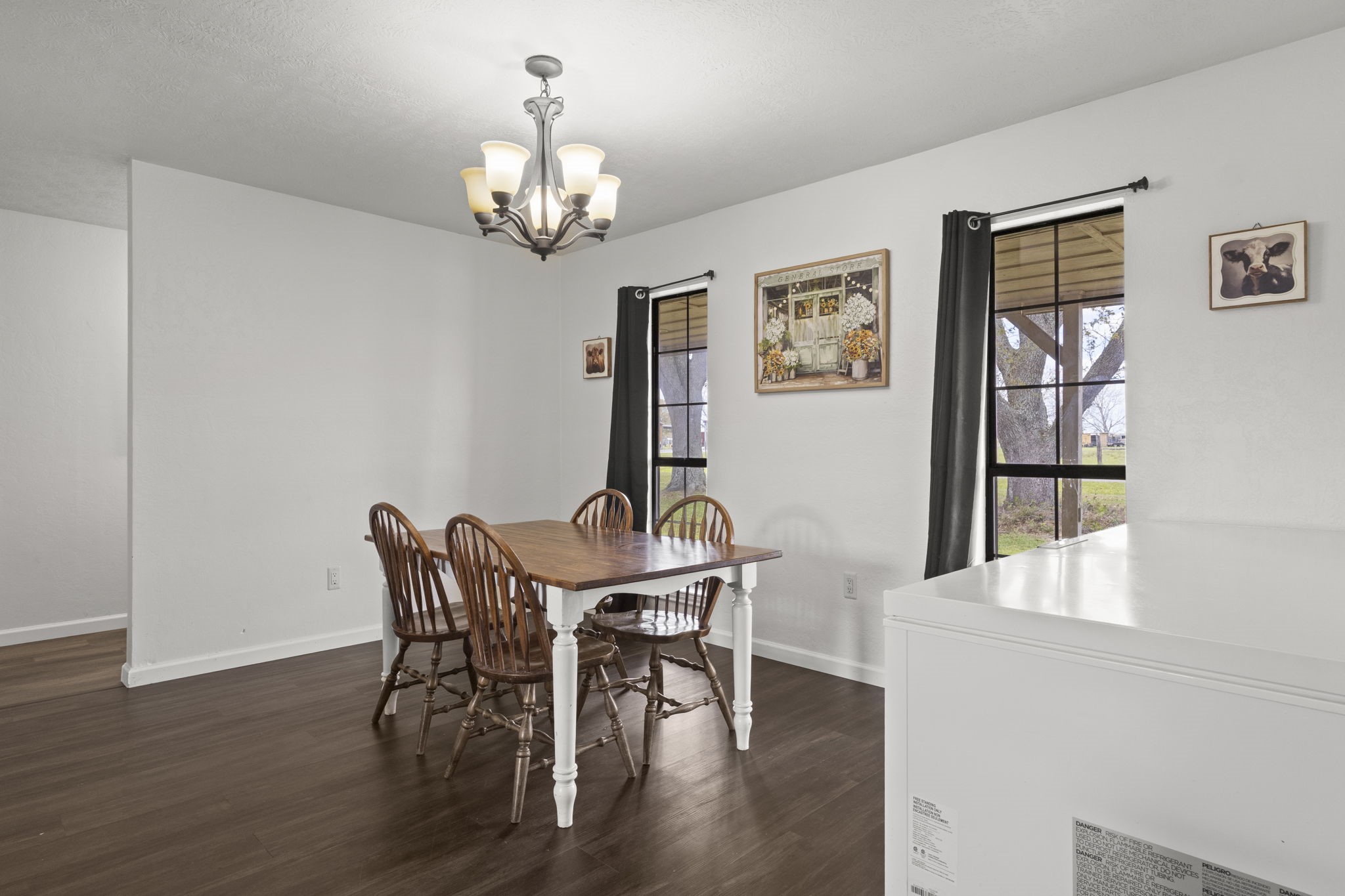 19961 Englin Road Winnie, TX 77665 - Photo 19 of 26 a view of a dining room with furniture wooden floor and chandelier