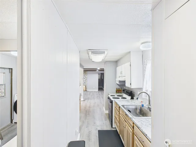 a kitchen with a sink cabinets and a window