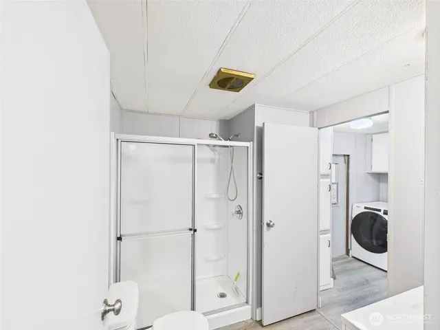 a bathroom with a shower and a sink
