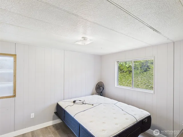 a bed sitting in a bedroom next to a window