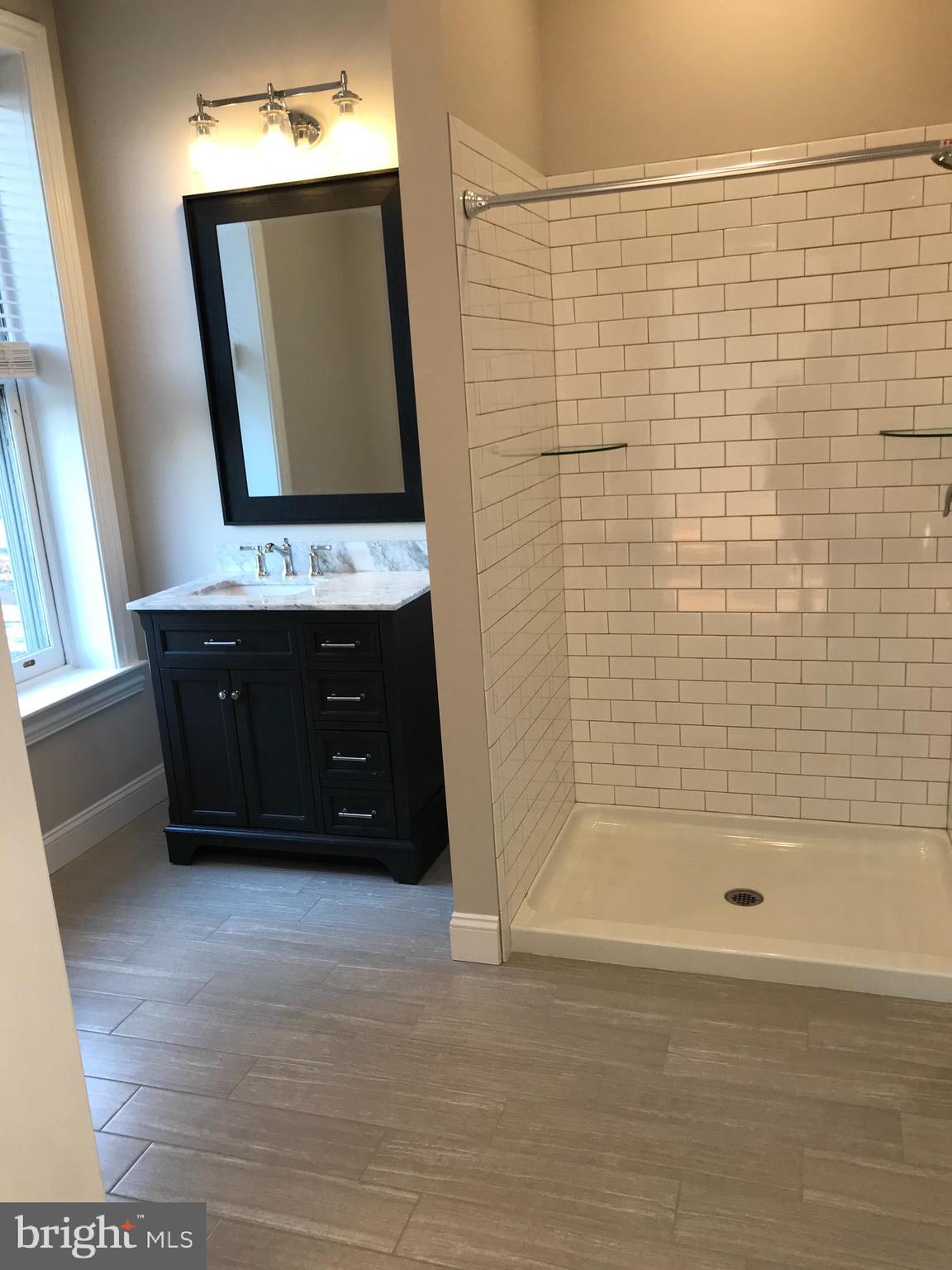 15 A Potter Street Haddonfield, NJ 08033 - Photo 3 of 11 a bathroom with a bathtub a mirror and shower