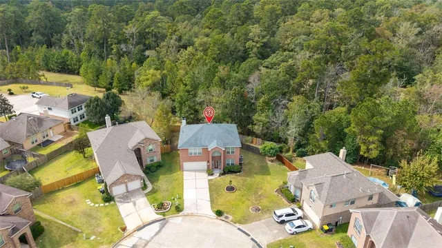 an aerial view of a house with swimming pool and garden view