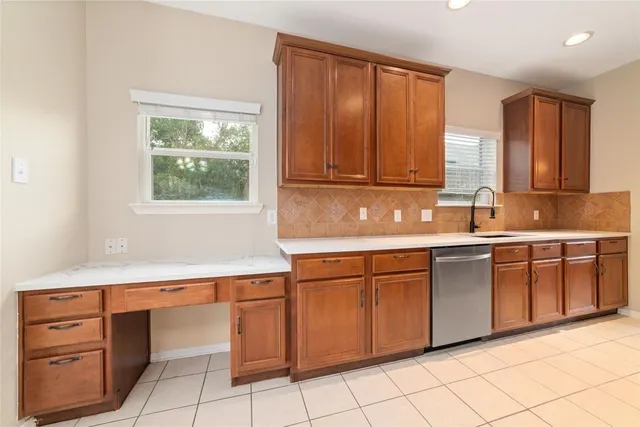 a kitchen with cabinets and window