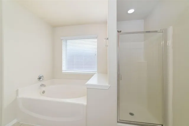 a white bath tub sitting next to a window
