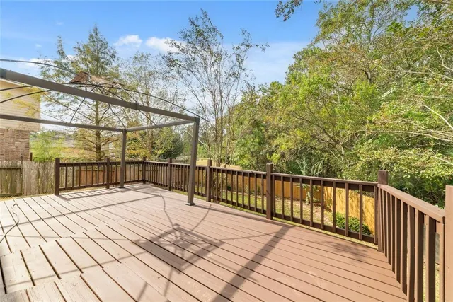 a view of balcony with wooden floor and fence