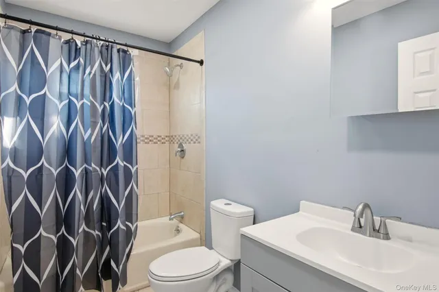 a white toilet sitting next to a bathroom sink