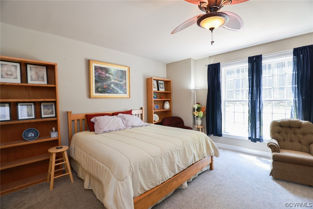 85 Rubermont Road Victoria, VA 23974 - Photo 16 of 49 a bedroom with a bed a dresser and a chandelier