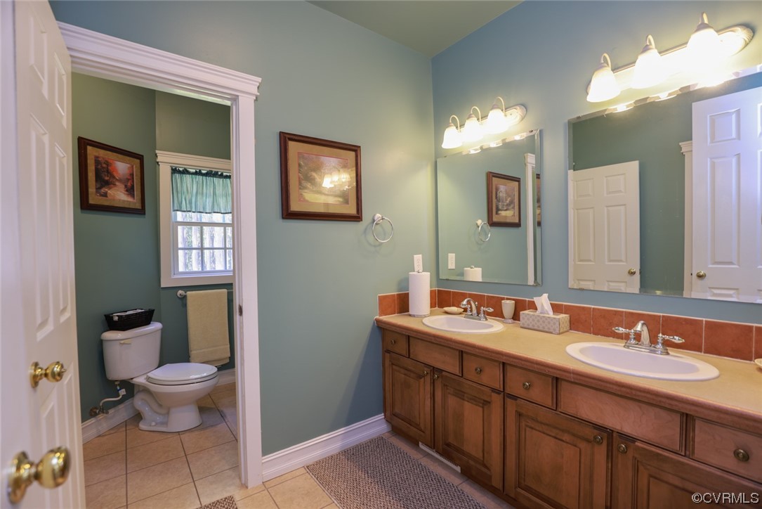 85 Rubermont Road Victoria, VA 23974 - Photo 24 of 49 a spacious bathroom with a double vanity sink toilet and a mirror