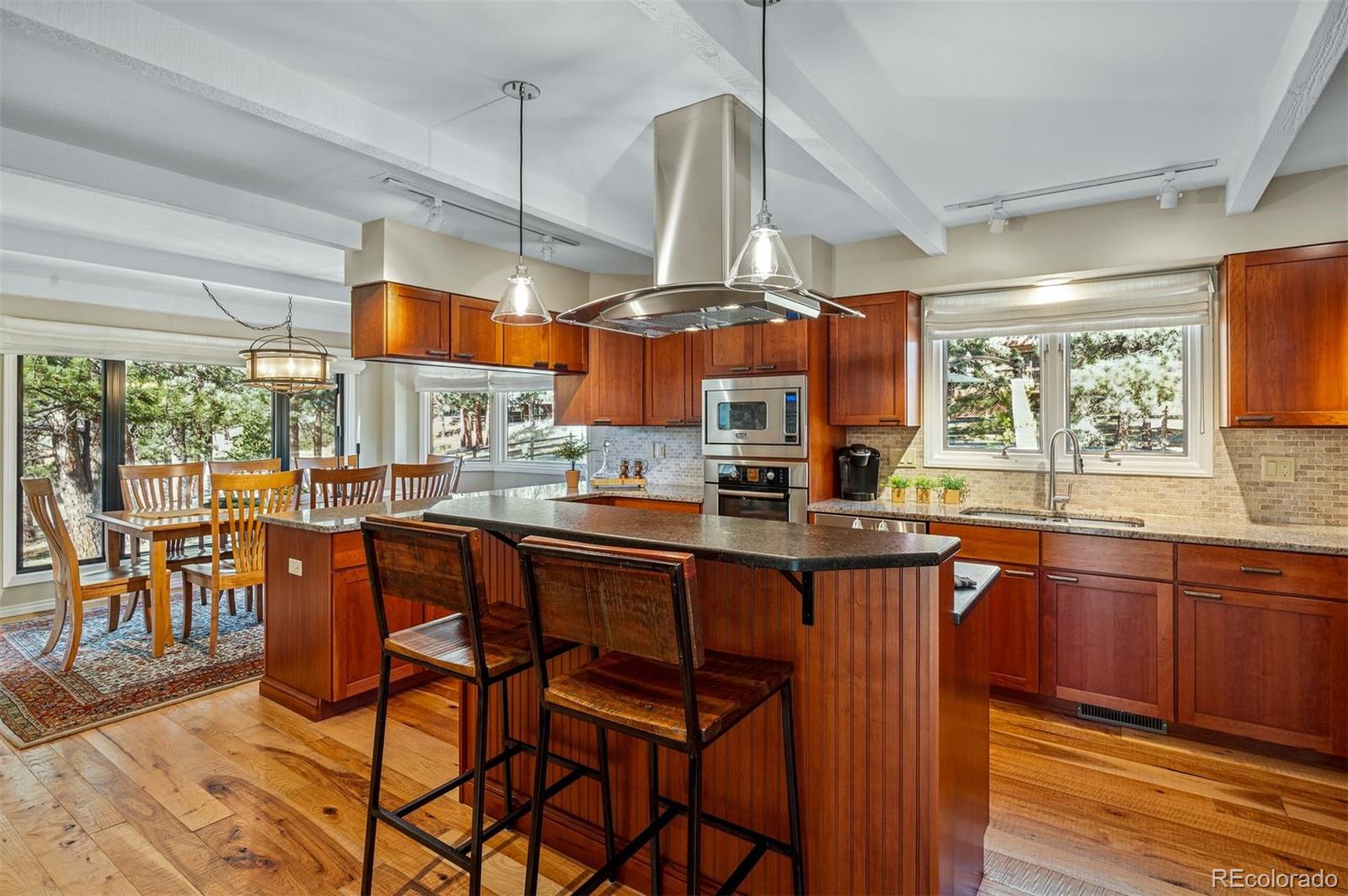 32329 Inverness Drive Evergreen, CO 80439 - Photo 11 of 48 a dining table chairs wooden floor and kitchen view