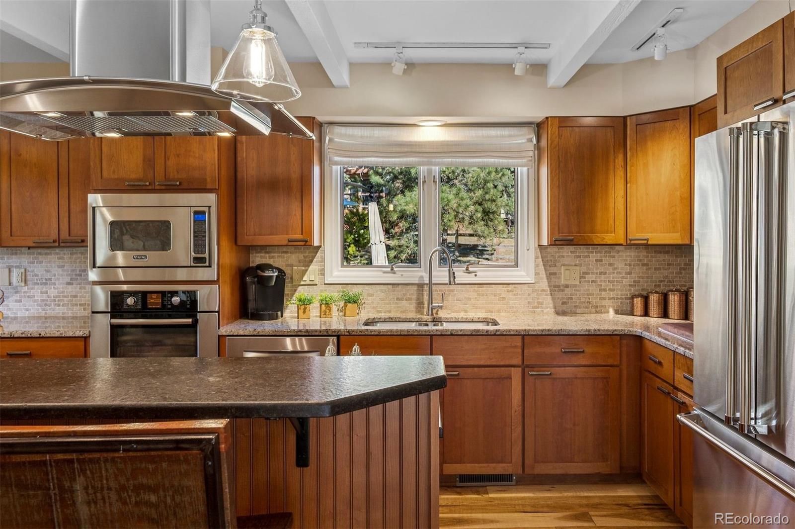 32329 Inverness Drive Evergreen, CO 80439 - Photo 13 of 48 a kitchen with a sink a counter top space cabinets and stainless steel appliances