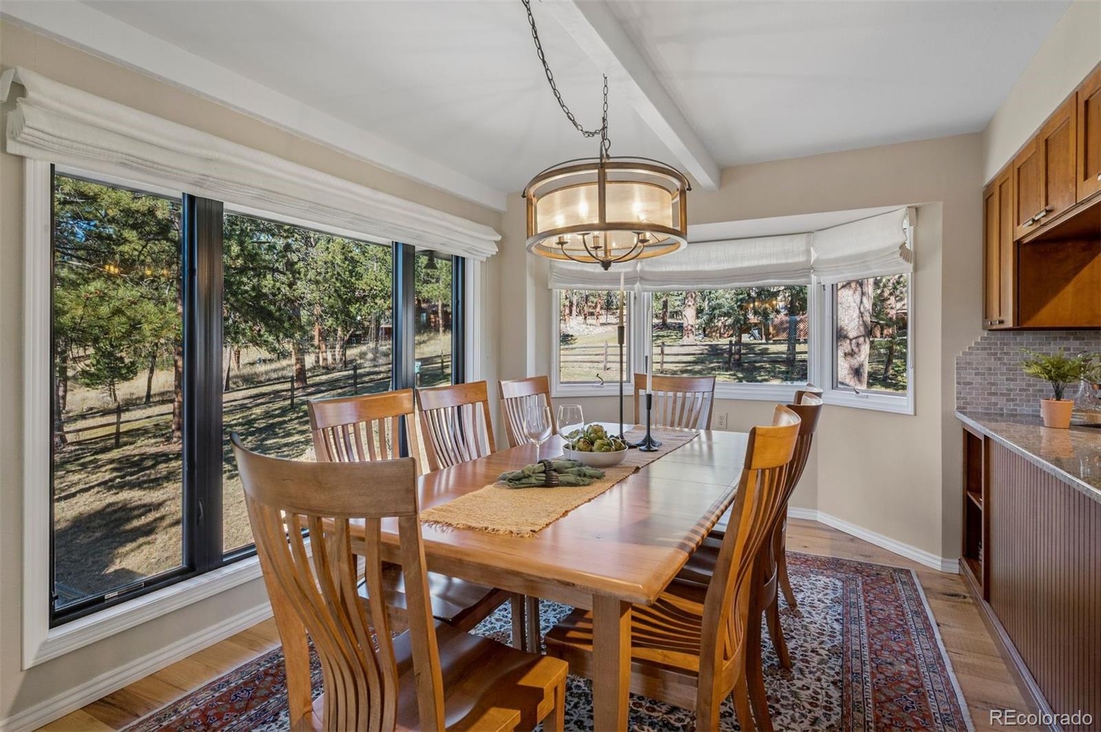 32329 Inverness Drive Evergreen, CO 80439 - Photo 15 of 48 a view of a dining room with furniture window and outside view