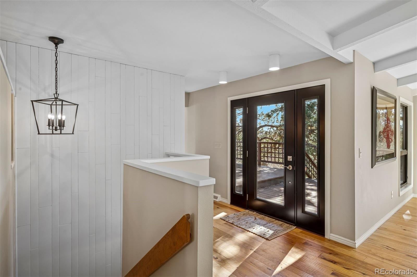 32329 Inverness Drive Evergreen, CO 80439 - Photo 20 of 48 a view of an entryway with wooden floor and door