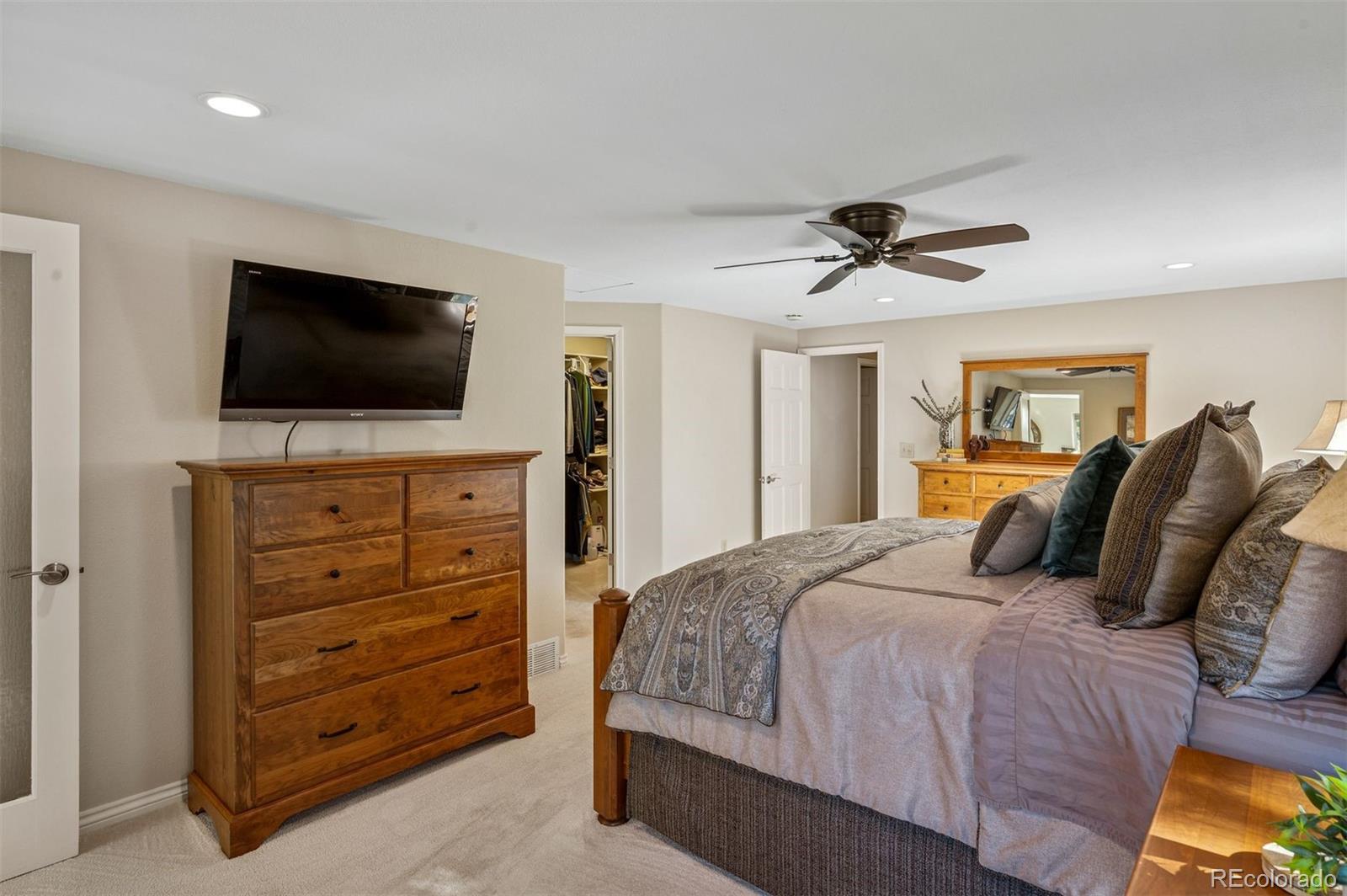 32329 Inverness Drive Evergreen, CO 80439 - Photo 22 of 48 a bedroom with a bed and a flat screen tv