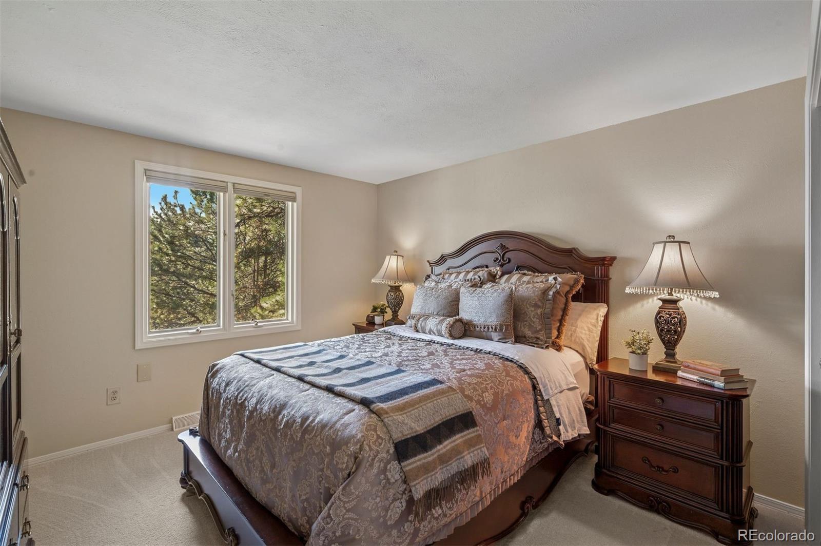 32329 Inverness Drive Evergreen, CO 80439 - Photo 28 of 48 a bedroom with a bed and window