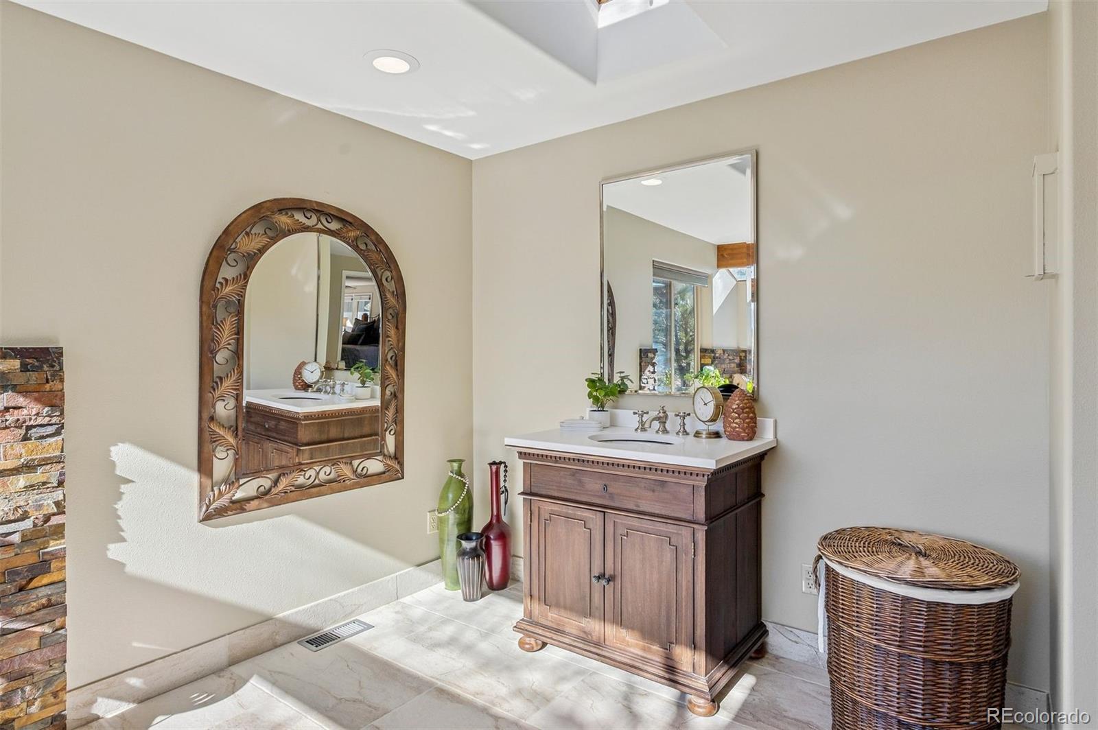 32329 Inverness Drive Evergreen, CO 80439 - Photo 29 of 48 a view of bathroom with a toilet a sink and a mirror