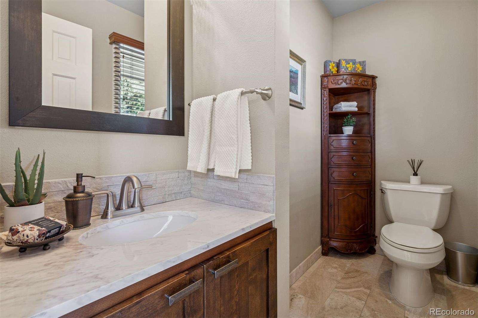 32329 Inverness Drive Evergreen, CO 80439 - Photo 32 of 48 a bathroom with a sink and a toilet