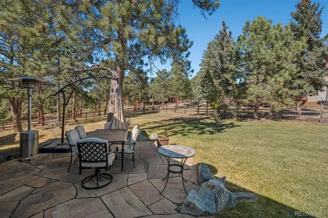 a view of a terrace with chairs and a table