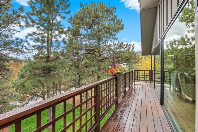 a view of balcony with wooden floor and fence