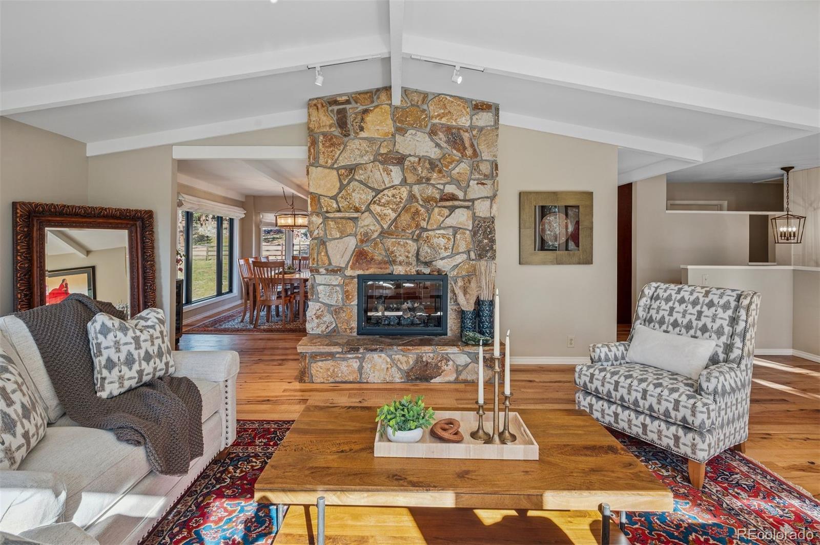 32329 Inverness Drive Evergreen, CO 80439 - Photo 6 of 48 a living room with furniture and a fireplace