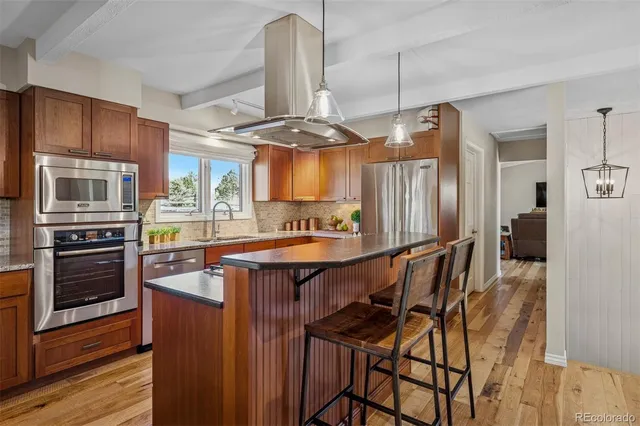 a kitchen with stainless steel appliances granite countertop a stove refrigerator and cabinets