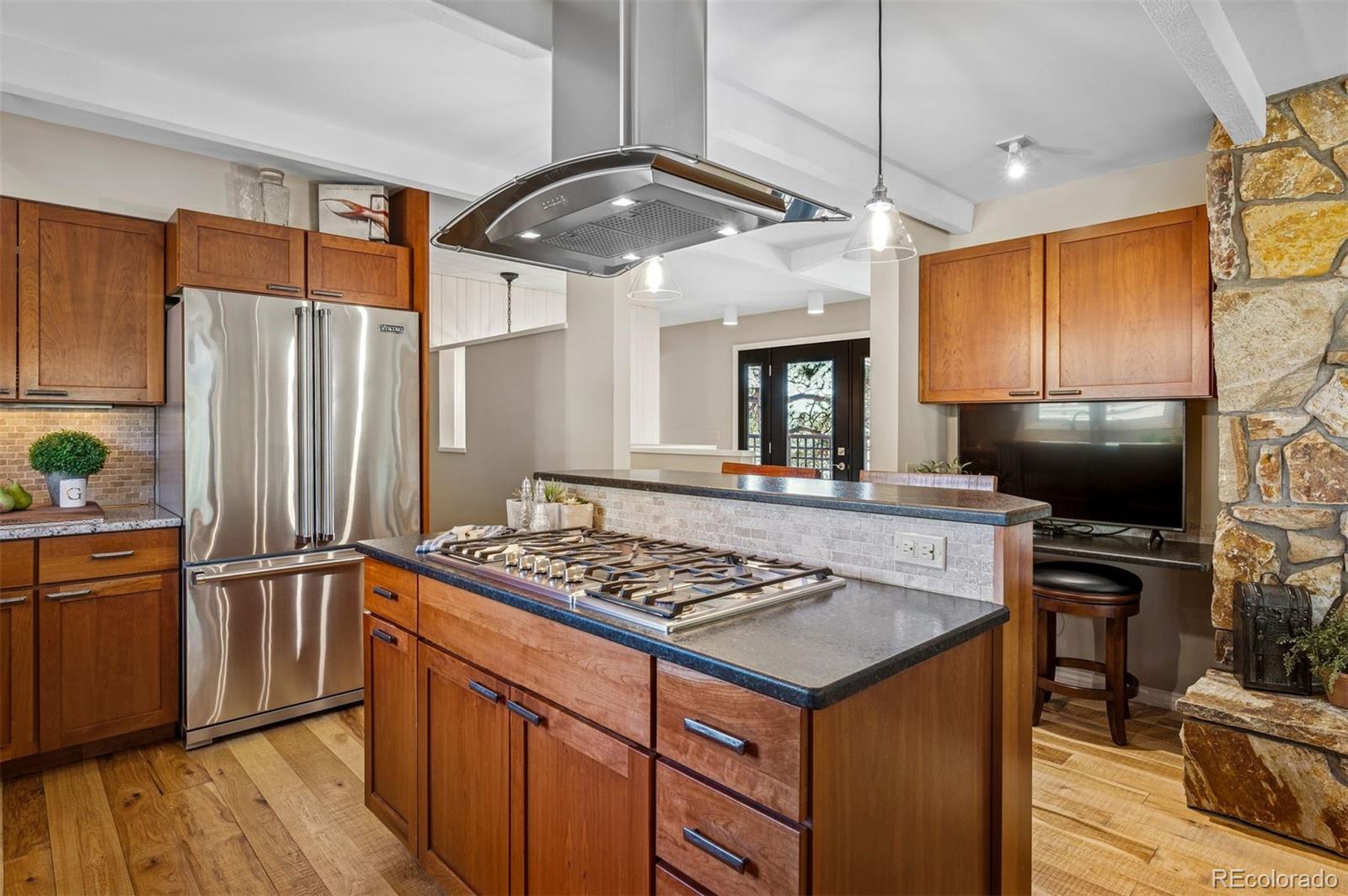 32329 Inverness Drive Evergreen, CO 80439 - Photo 10 of 48 a kitchen with stainless steel appliances granite countertop a stove refrigerator and microwave