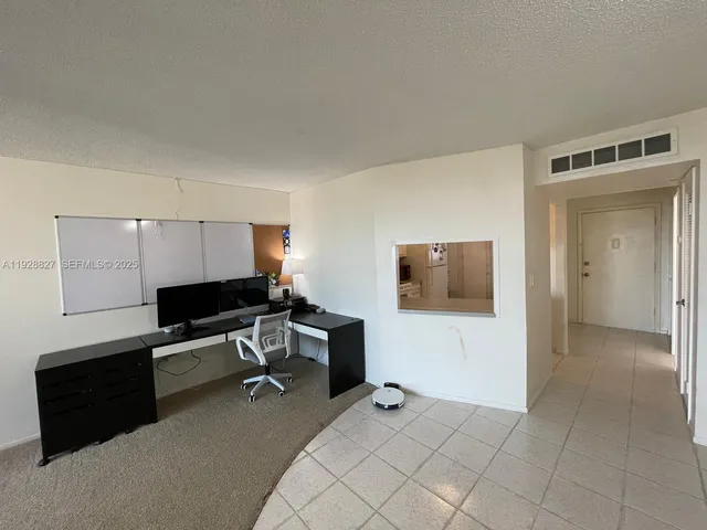 a view of a livingroom with furniture and a flat screen tv