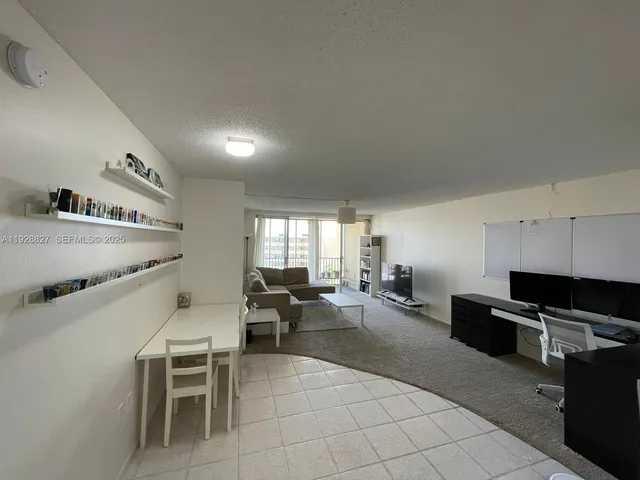 a living room with furniture a flat screen tv and a window