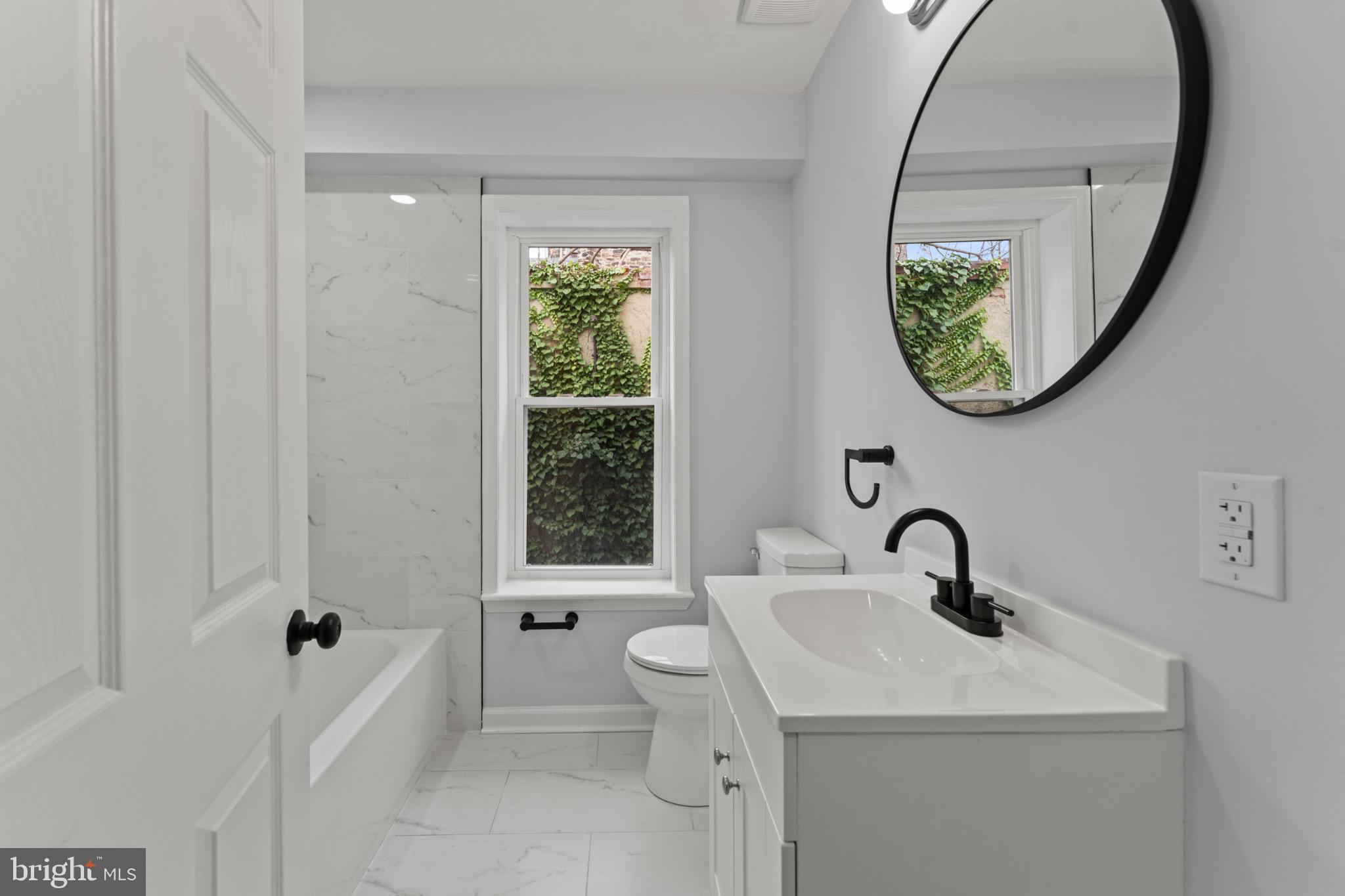 917 Edmondson Avenue Baltimore, MD 21223 - Photo 16 of 27 a bathroom with a toilet sink and a mirror