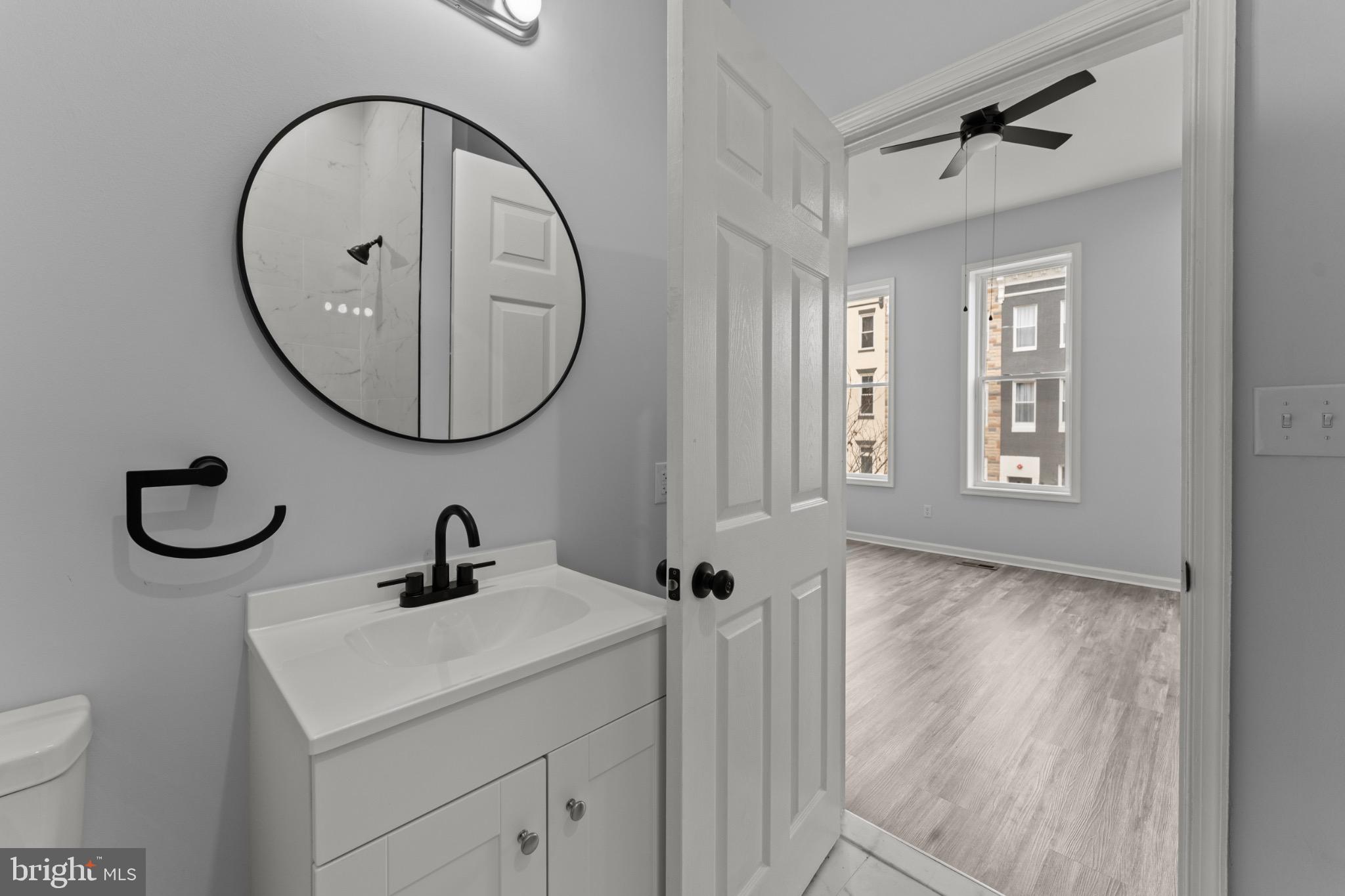 917 Edmondson Avenue Baltimore, MD 21223 - Photo 22 of 27 a bathroom with a sink and a mirror