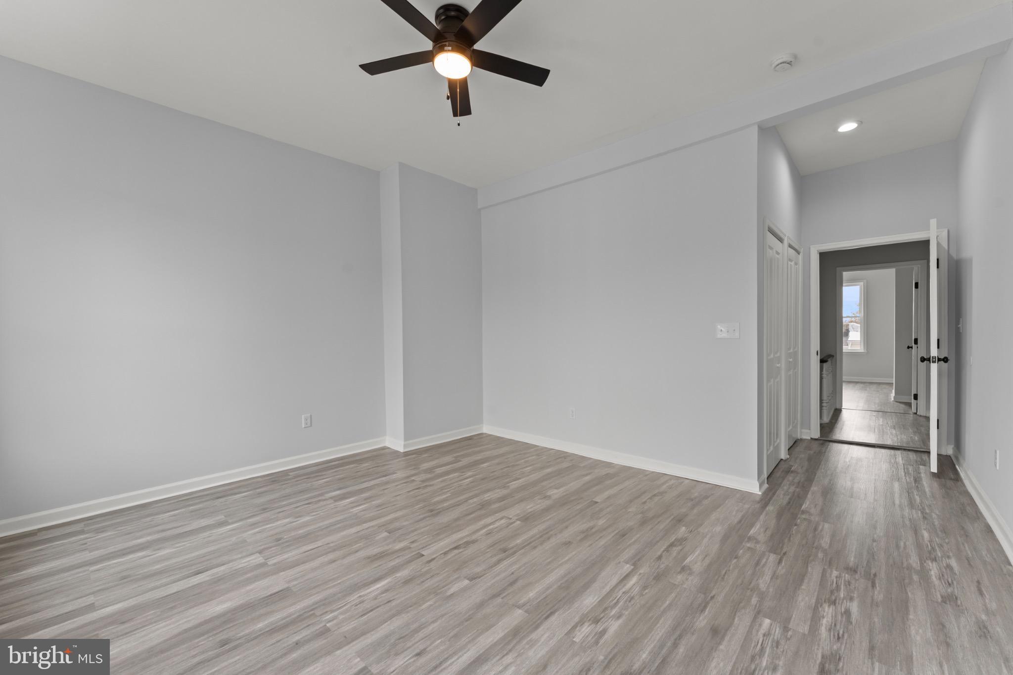 917 Edmondson Avenue Baltimore, MD 21223 - Photo 25 of 27 wooden floor in an empty room with a window