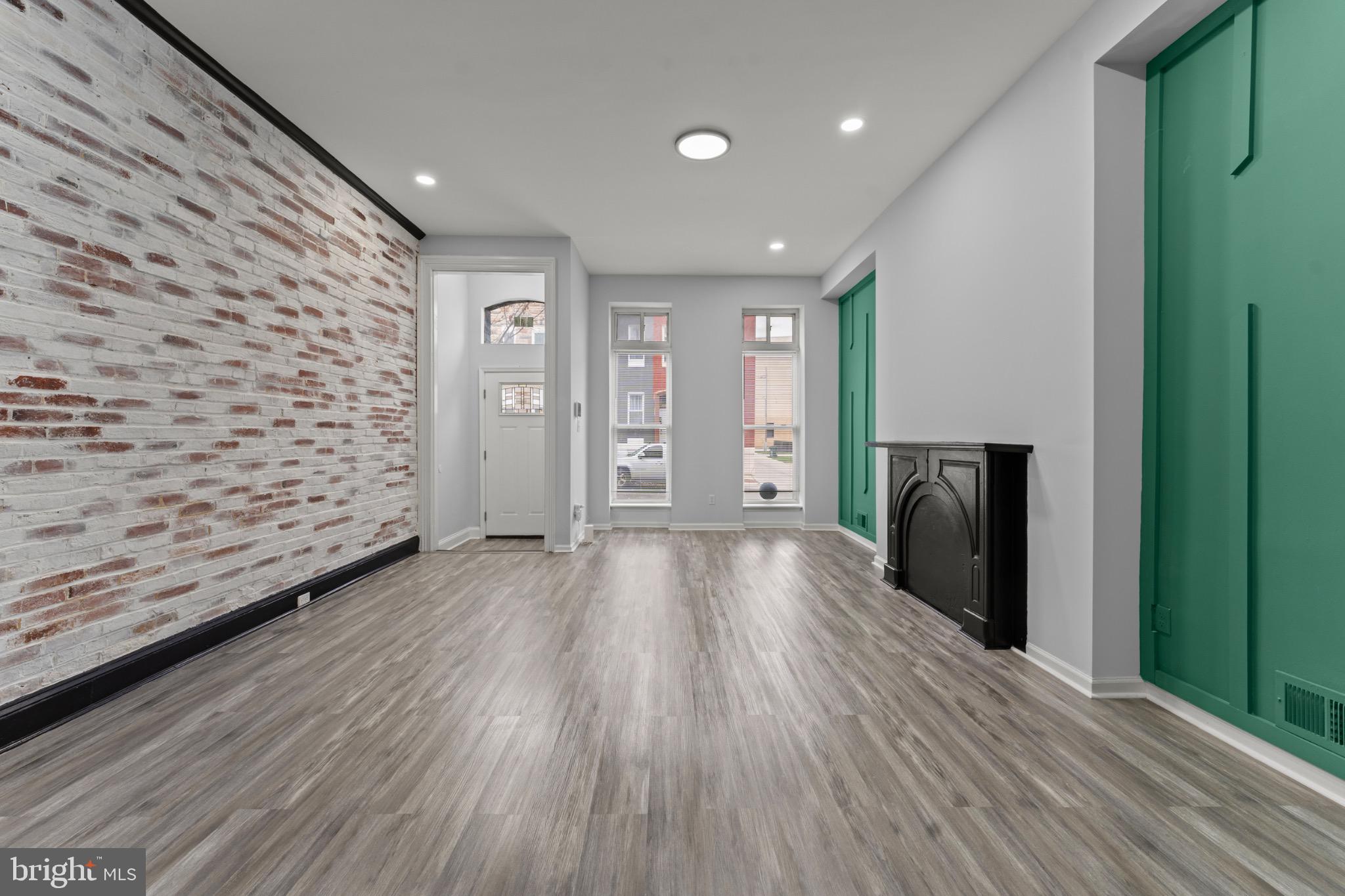 917 Edmondson Avenue Baltimore, MD 21223 - Photo 3 of 27 a view of a hallway with wooden floor and staircase