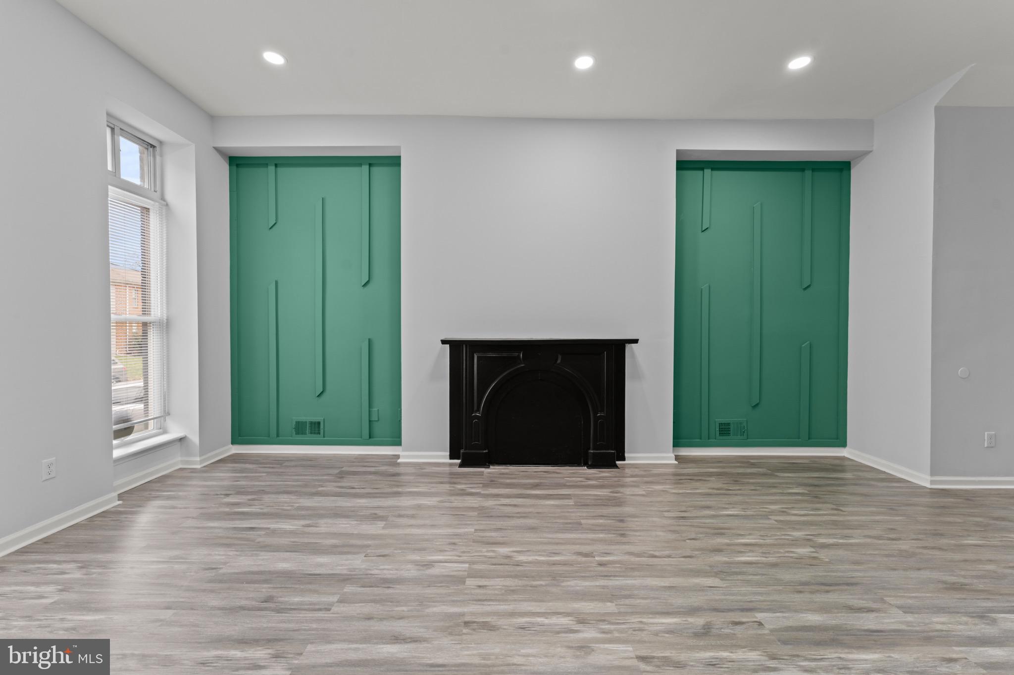 917 Edmondson Avenue Baltimore, MD 21223 - Photo 5 of 27 a view of an empty room with wooden floor and a window