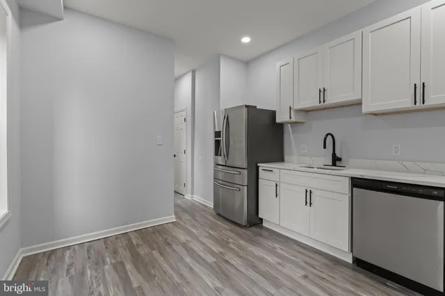 a kitchen with a sink a stove and cabinets