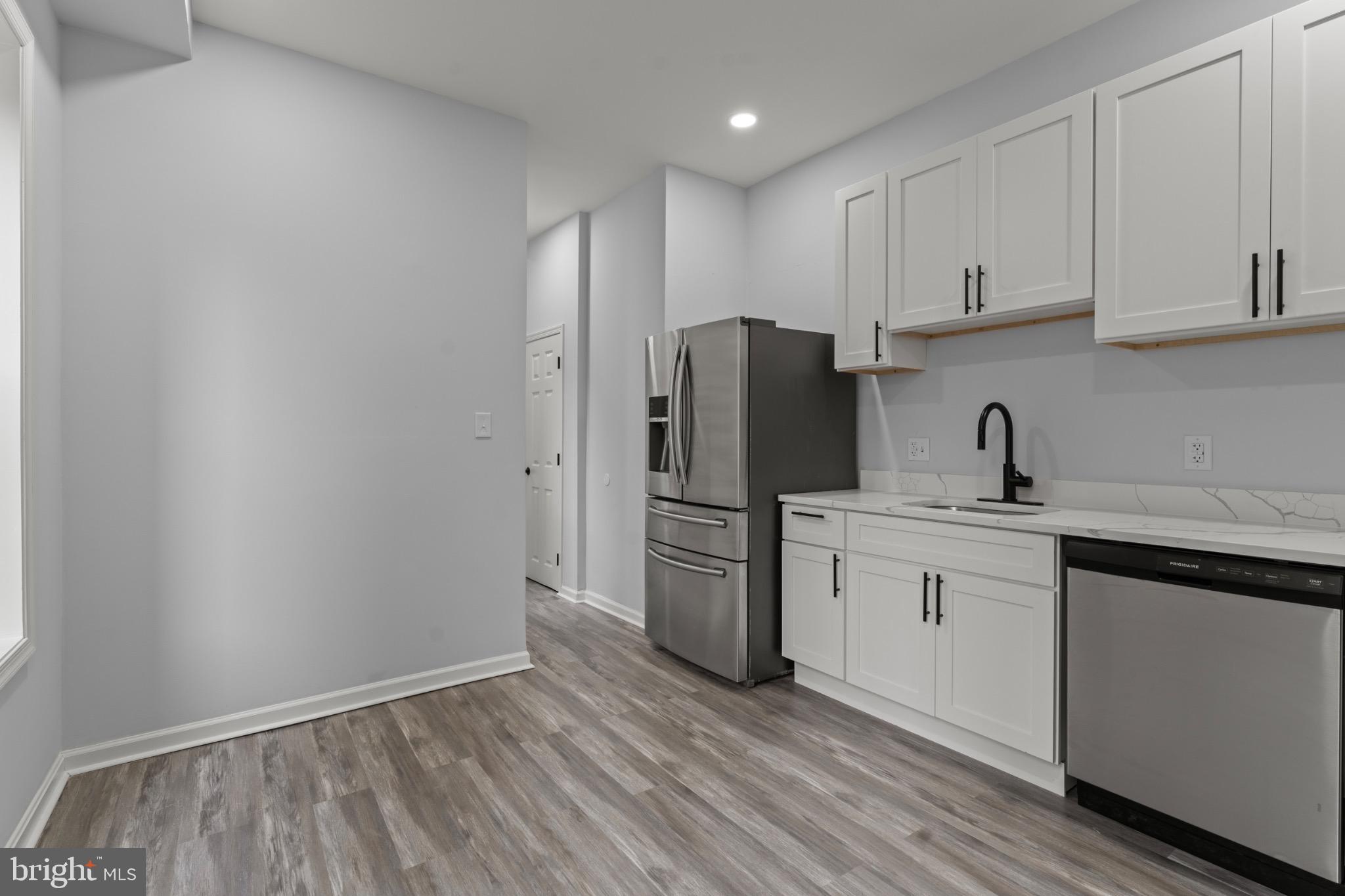 917 Edmondson Avenue Baltimore, MD 21223 - Photo 10 of 27 a kitchen with a sink cabinets stainless steel appliances and cabinets