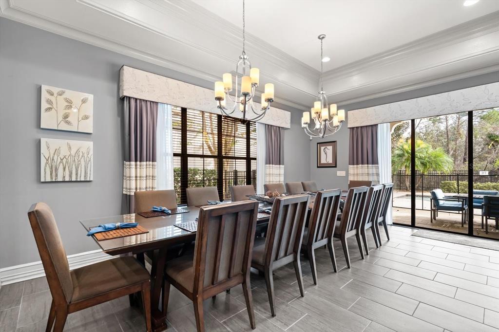 1105 Watson Court Reunion, FL 34747 - Photo 12 of 61 a view of a dining room with furniture large windows and wooden floor
