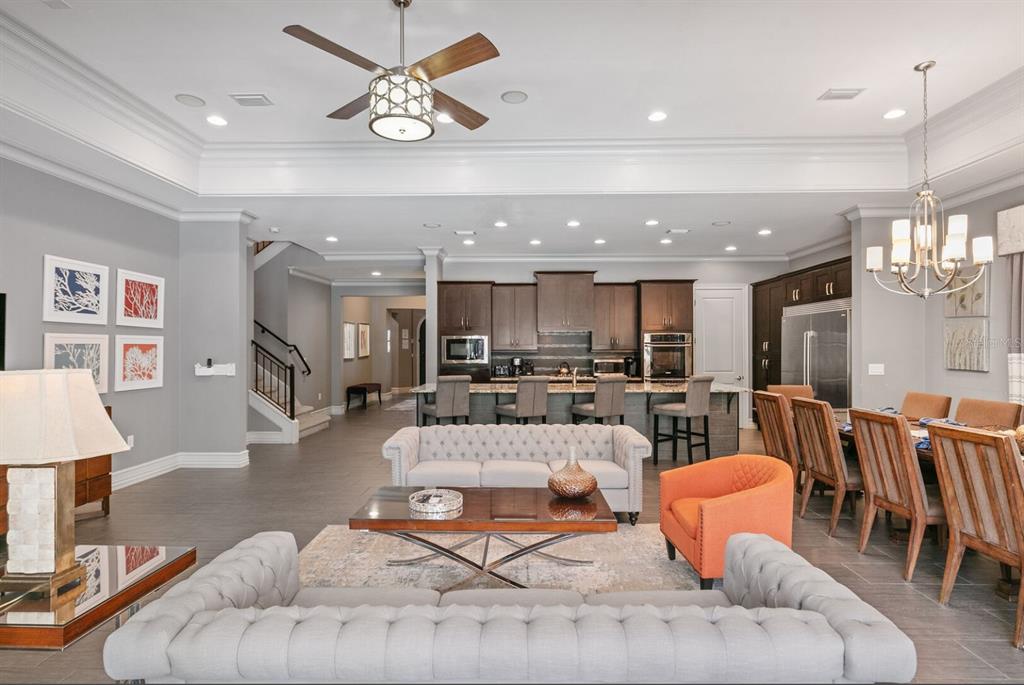 1105 Watson Court Reunion, FL 34747 - Photo 17 of 61 a living room with furniture kitchen view and a chandelier